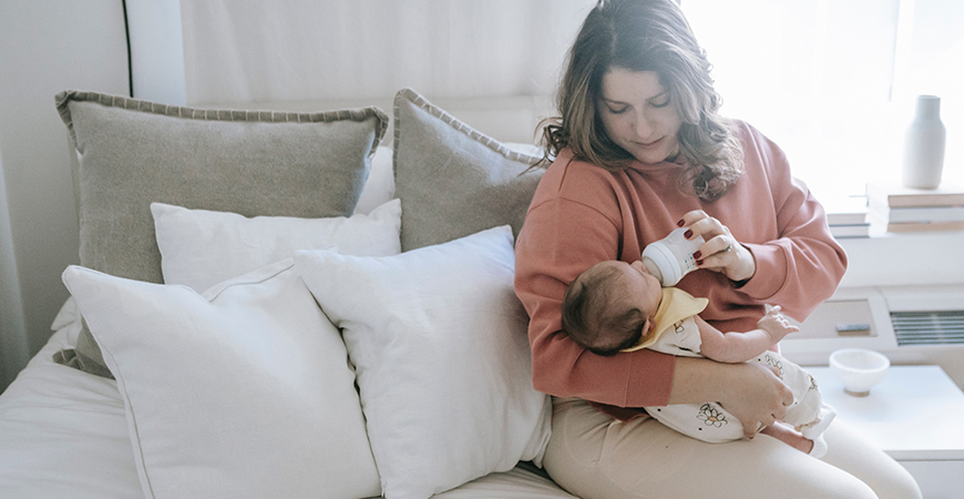 A mother bottle-feeds her baby.