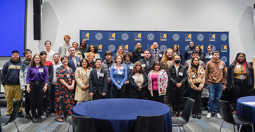 Attendees of "Dinner for Champvocates" pose for a photo.