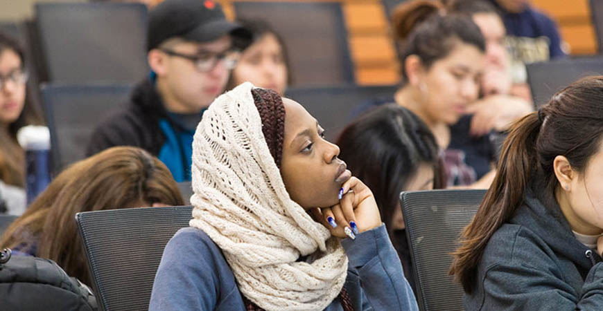 Woman in classroom listening to lecture