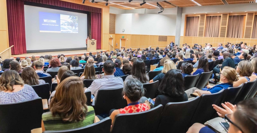 Hundreds of UC Merced staff members listen to Chancellor Dorothy Leland speak inside the Dr. Lakireddy Auditorium.