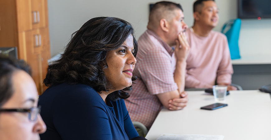 Dania Matos talks with staff on campus