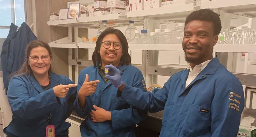 Professor Eva de Alba, Eduardo A. Gaspar-Morales and Ayomide J. Adeoye display a hydrogel. 