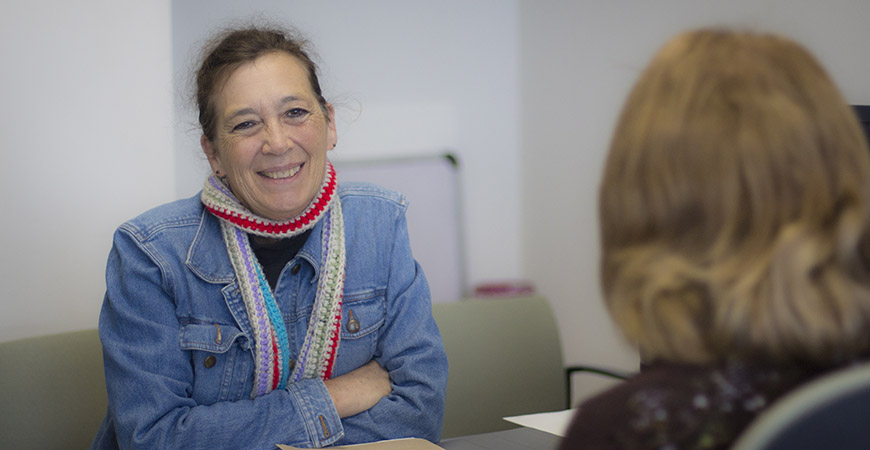 two women talking in a office