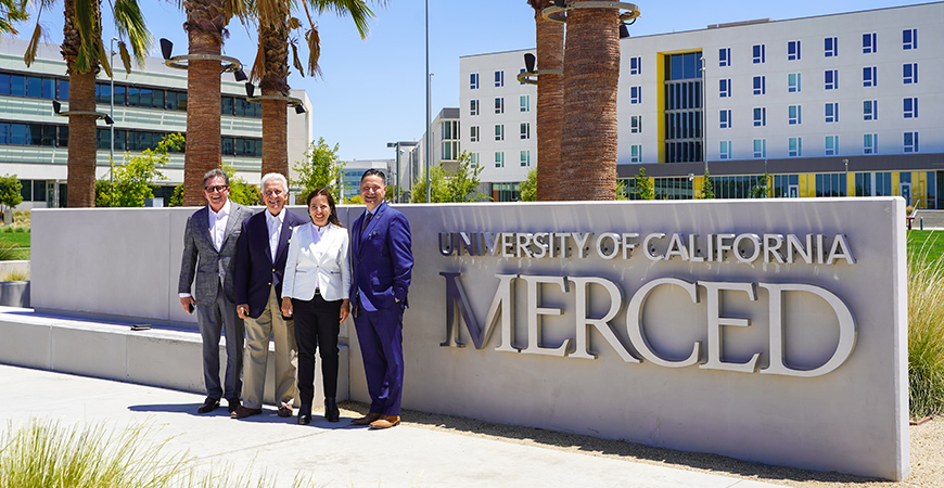 Former Assemblymember Rusty Areias, U.S. Rep. Jim Costa, Lt. Gov. Eleni Kounalakis and UC Merced Chancellor Juan Sánchez Muñoz pose for a photo on the UC Merced campus.