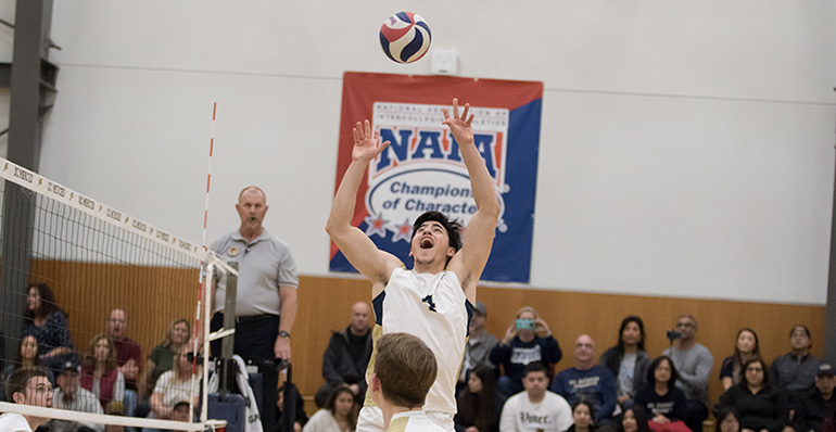 Joey Medina sets a ball for his teammate during a match.