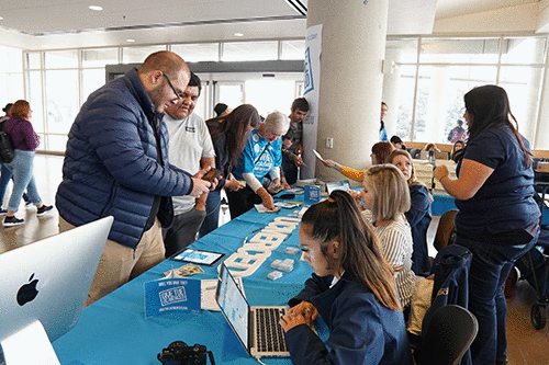 Arturo Raudales (left) and Jorge Mendieta donate while Carolyn Vara matches another student's contribution